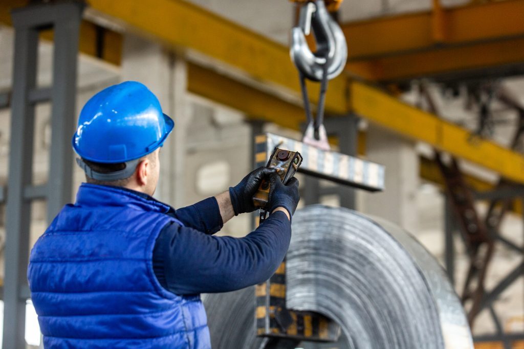 worker uses control joystick in factory